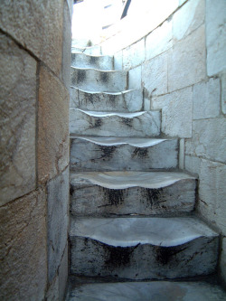 The worn marble steps at the Leaning Tower of Pisa. This is the result of 500 years of walking. 