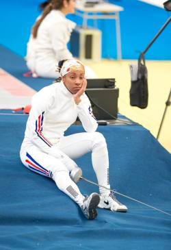 modernfencing:  [ID: an epee fencer sitting on the side of a strip, chin in hand.]A fencer at the 2015 Pan-Ams! (Photo by Devin Manky.)