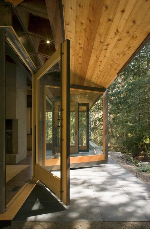 archatlas:    Tye River Cabin Olson KundigSituated in a dense forest near the Tye River, this meditative retreat connects to the nature that surrounds it.The square base of the two-level structure is rendered in cast-in-place concrete, as is the large