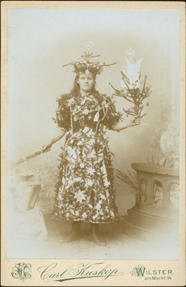 Hey guys! I’ve returned from another hiatus, and am hoping to find you in good holiday spirits, with enough zeal to compete with this fine lady’s.
ca. 1900, [young lady dressed as a Christmas Tree], Carl Kuskop