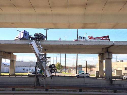 An 18-wheeler overturned Saturday morning and was partially hanging from the upper level of eastboun