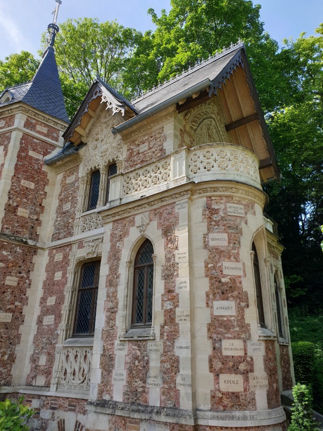 a closer view of the castle to show the stones carved with names like amaury, cecile and georges