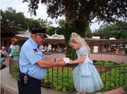 stunningpicture:  The security guard at Disneyland asks a little girl for an autograph, pretending that he mistook her for a ‘princess’.  Adorable.