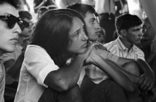 bobdylan-n-jonimitchell:  Bob Dylan and Joan Baez in the audience at the Newport Folk Festival, July 1963.