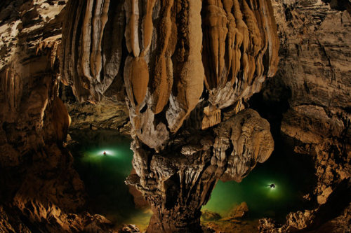 archatlas:    Hang Son Doong Carsten PeterLike a castle on a knoll, a rock formation shines beneath a skylight in Hang Son Doong. A storm had just filled the pool, signaling that exploring season was coming to an end. [via]