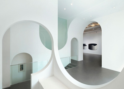 dezeen:  A sequence of arches creates topsy-turvy openings and curvy doorways through the spaces of this art gallery in Beijing 