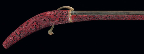 Elaborately carved and red lacquered Chinese matchlock musket, Qianlong/Jiaqing Period (1732-1820)So
