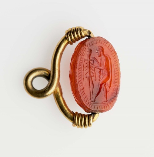 gemma-antiqua:Left: Roman carnelian scarab intaglio of Prometheus creating man, dated to 100 BCE. Ri