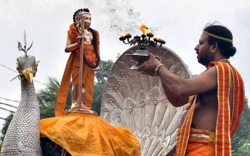 Priest worshipping Murugan