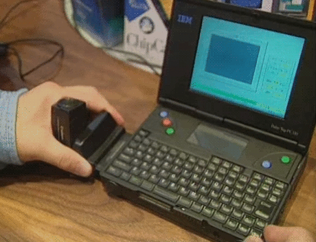 contac:Also at the Winter 1996 CES was the IBM Palm Top PC110, shown here with the Canon CE300 camer