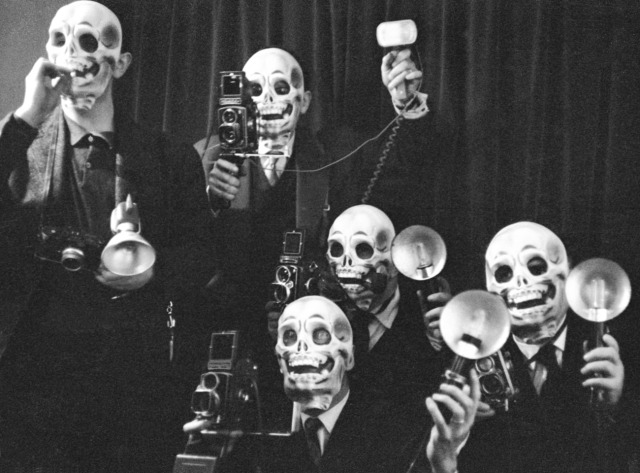 Actress Béatrice Altariba with photographers wearing skull masks at the premiere of the film 