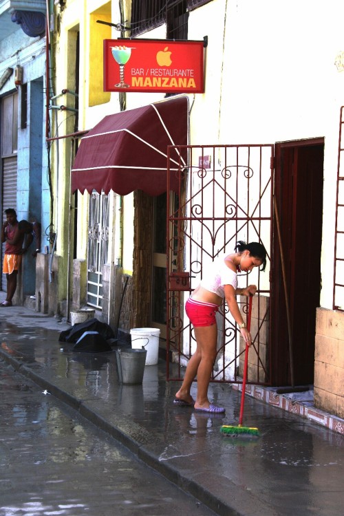 Cleaning up the store front in Old Havana.