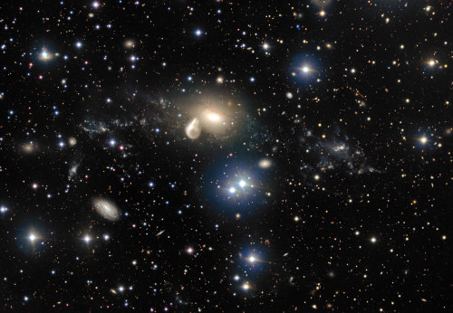 willymaykit:VLT Revisits a Curious Cosmic CollisionNGC 5291, the hazy, golden oval dominating the ce