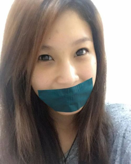 Asian Girl fake tape gagged.