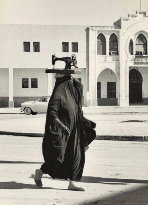 kvetchlandia:Jean-Philippe Charbonnier     Woman Carrying Sewing machine, Kuwait     1955