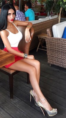 formmb:Sexy, exotic woman in red mini skirt.  Hot long legs accentuated by sky high stiletto heels