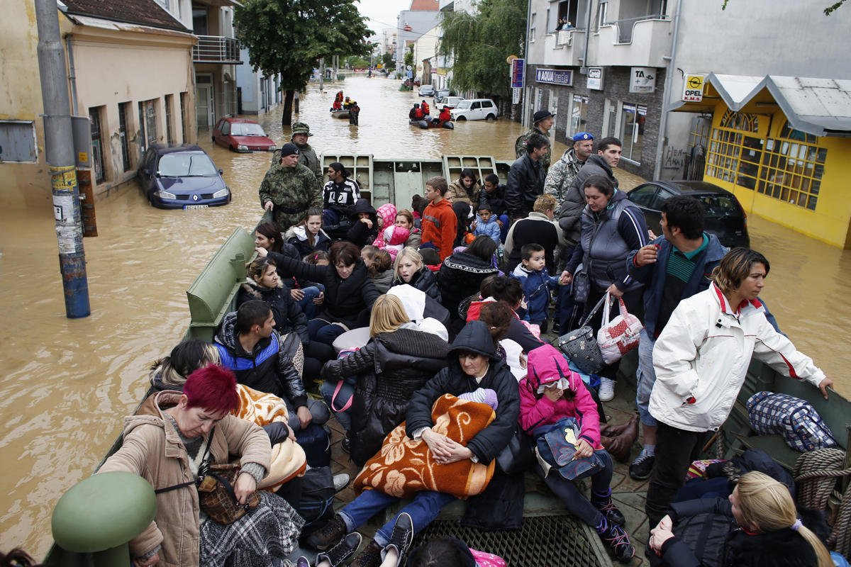 merosezah:  1. A Serbian rows a boat past flooded ambulance vehicles in the flooded