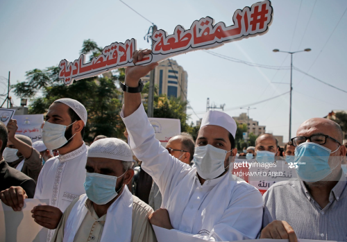 Palestinians holding a demonstration against the comments of French President Emmanuel Macron over t