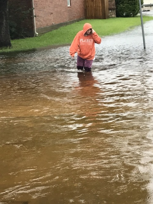 On one of the most well off streets, in the most shallow end, after the rain had come to a stop for a while and a lot of it had still evaporated, my boyfriend took a picture of me in water that was still up to my knees.