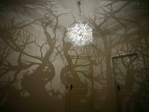 thisisfandom:itscolossal:This chandelier from Hilden &amp; Diaz projects the shadow of a forest 