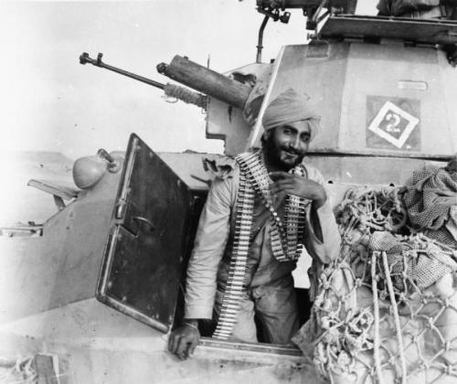 qsy-complains-a-lot:worldwar-two:The Indian operator of a light armored vehicle displays bullets for