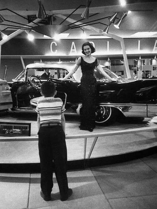 Boy watches model on the Cadillac Eldorado display at the New York auto show / photo by Walter Sande