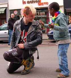 Tough Enough (A Punk Rocker Kneels Down To Let A Young Boy Touch The Spikes On His