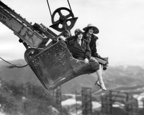 vintageeveryday: Two ladies are suspended high above the Hollywoodland sign as they ride on the shov