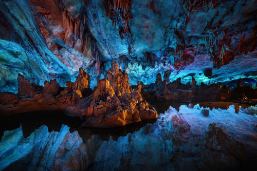 sixpenceee:    The Reed Flute Cave    The Reed Flute cave is a popular tourist attraction in Guilin, China. Inside this water-eroded cave is a spectacular world of various stalactites, stone pillars and rock formations created by carbonate deposition.