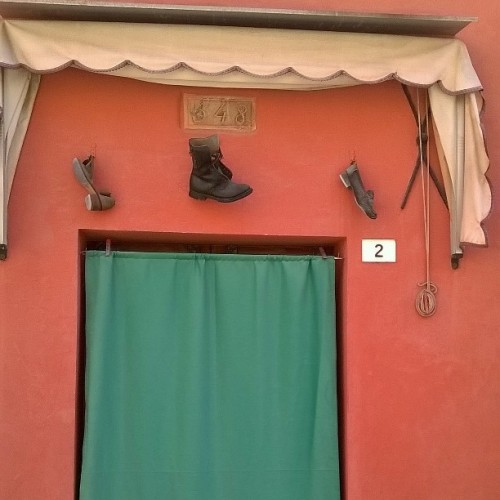 Door with three shoes hanging over….. #doorway #shoes #santarcangelo #Italia #ports #scarpe #