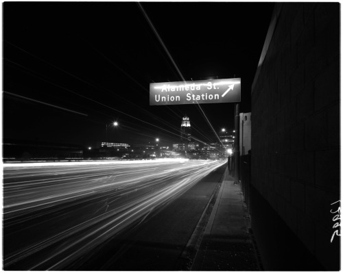 Los Angeles City Hall and traffic on the 101, viewed from the Alameda Street off-ramp. Night, 1961.