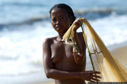 Topless Madagascan girl fishing.