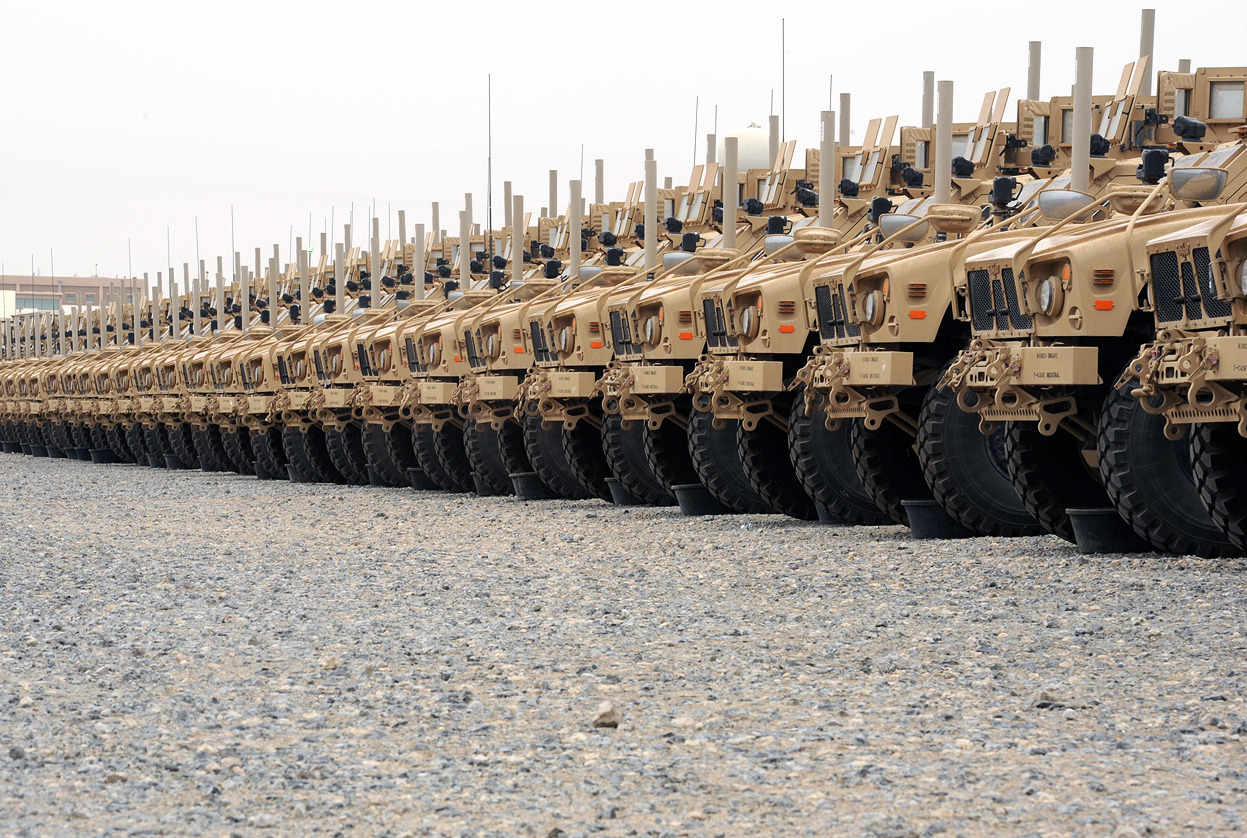 From Afghanistan: The Long Withdrawal, one of 38 photos. Here, Mine-Resistant Ambush Protected (MRAP) vehicles wait in a staging area for onward movement at an undisclosed base in Southwest Asia. The joint team of Marines, soldiers, sailors and...