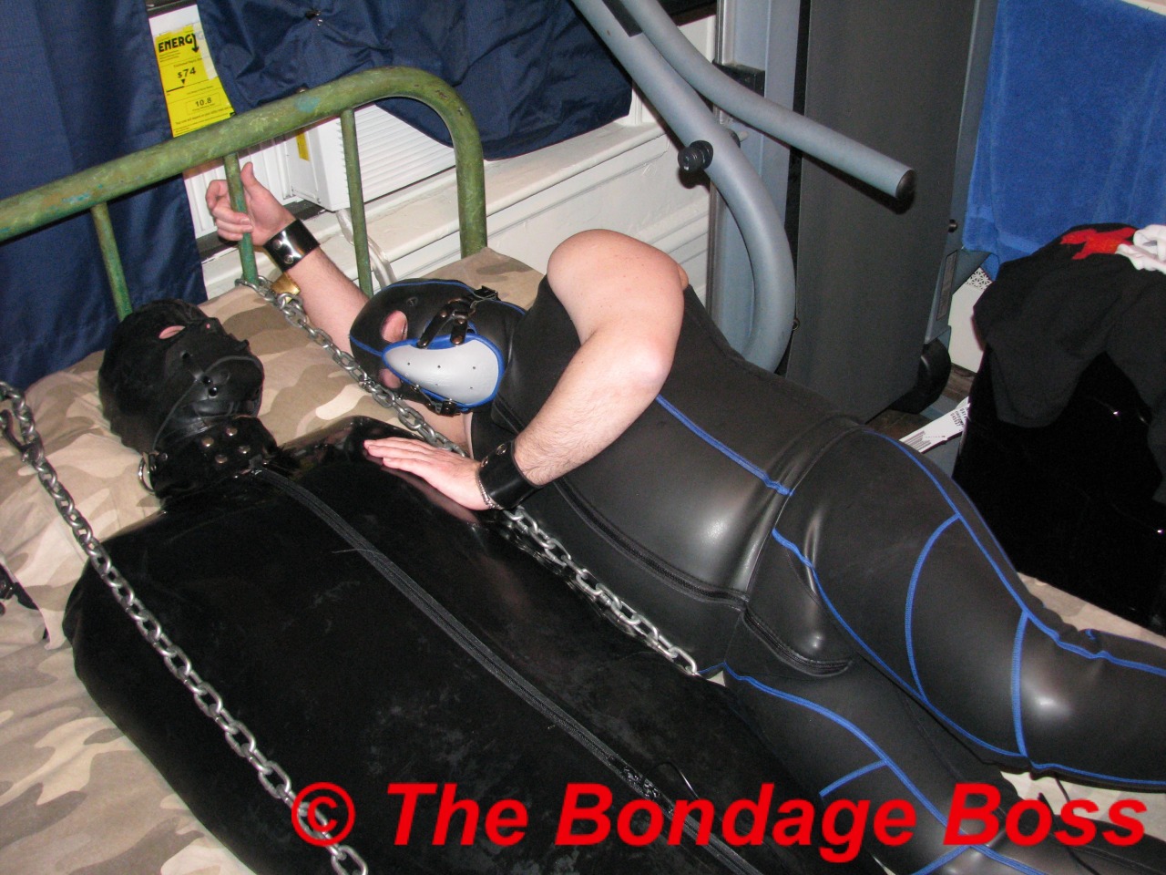 thebondageboss:  The Canadian bondage pig still in the sleepsack joined by my slave