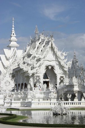 madeleineengland:  Wat Rong Khun, better known to foreigners as the White Temple, is a contemporary, unconventional, privately-owned art exhibit in the style of a Buddhist temple in Chiang Rai, Thailand. Chalermchai Kositpipat constructed it and