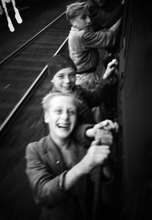vintageeveryday: Photographs of excited Dutch boys hanging on a moving train after the Liberation, 1