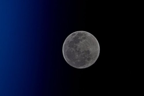 OrbAstronaut Jack Fischer took this photo of the moon with the barest hint of the top of Earth’s atm