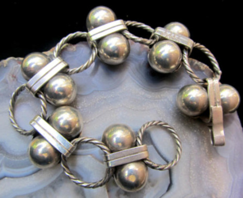 An early piece, circa 1930s, meticulously crafted by hand. This bracelet with chain of heavily worke