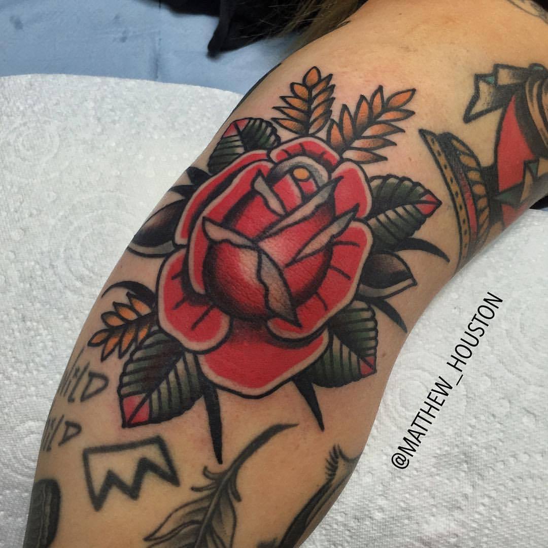 Black and grey rose tattoo on the inner elbow