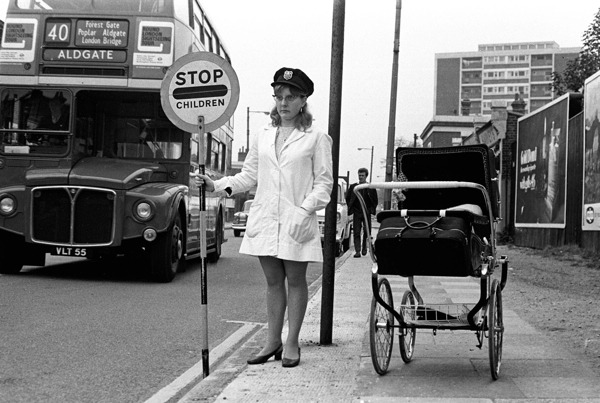 Lollipop lady at work in the East End during the 1960s with her baby in the pram.
Photograph taken from London’s East End A 60s Album published by The History Press