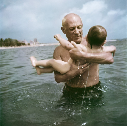 Pablo Picasso playing in the water with his son Claude, Vallauris, France, 1948. © Robert Capa/