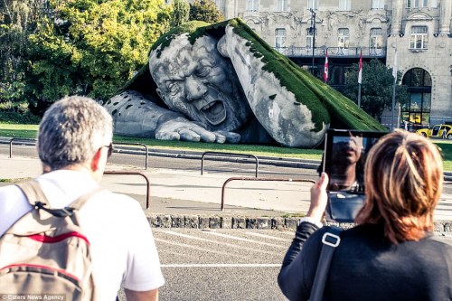 sixpenceee:  Hungarian artist Ervin Herve-Loranth is responsible the enormous sculpture, entitled ‘Feltépve’ which translates as ‘ripped up’ or ‘pop up’. The gigantic man appears to be emerging from underneath a blanket of grass. It was