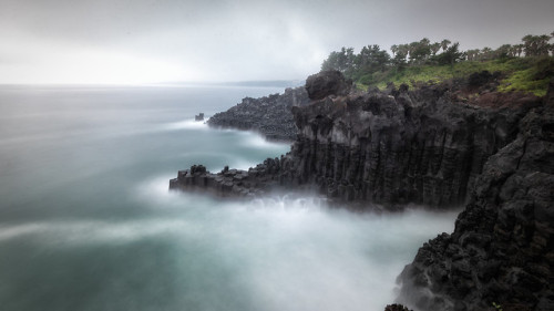 Basalt cliffs of Jeju&rsquo;s Daepo Coast, a breathtaking example of columnar jointing, or 