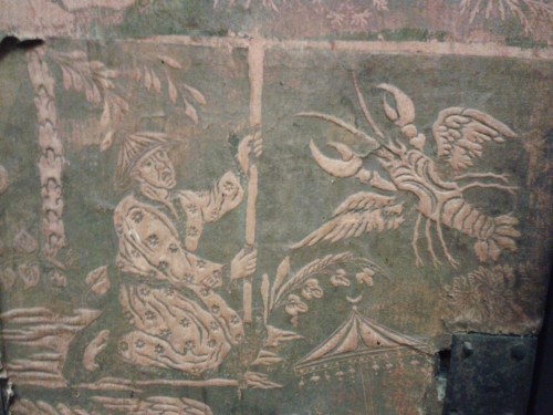 Man in duel with giant flying clock-dwelling lobster. Printed wallpaper from inside a japanned/lacqu