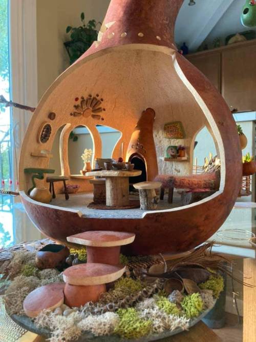 miniatureworlds:Gourd fairy house by Mary-Ella Bowles‘I make Fairy houses out of gourds, with the furniture and landscaping made of gourd scraps, twigs, bark, pods, seeds and other natural materials. I display them in my art studio where people