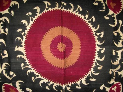 Fragment of antique Suzani, traditional decorative wall hanging, ethnic textiles. Silk embroidery on