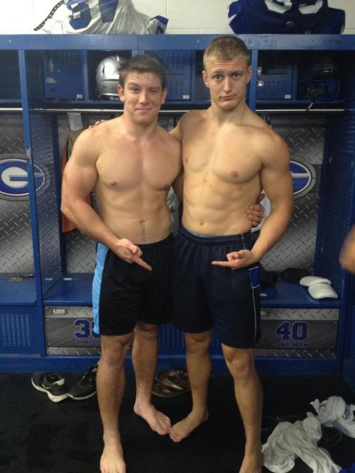 A couple of shirtless bros in the locker room