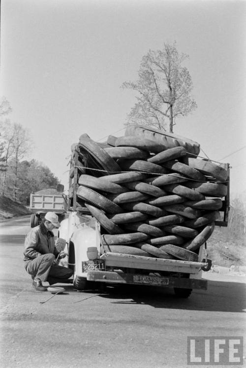 Truck full of tires has a flat(Robert W. Kelley. 1956?)