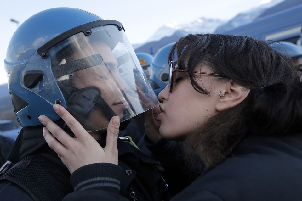   A demonstrator kissed a police officer during a protest in Susa, Italy, against
