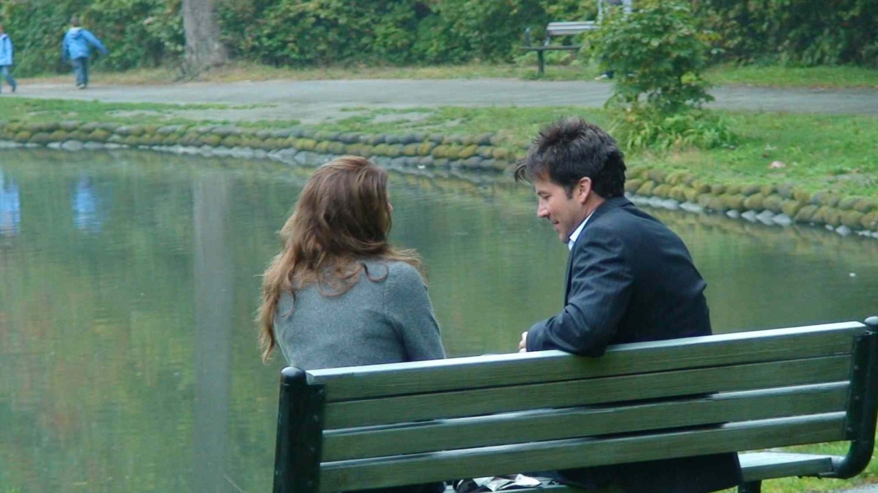 Nancy and John Sheppard on the park bench in “Outcast”.